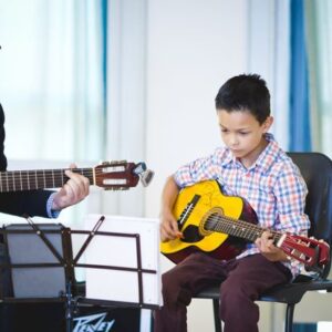 kid taking guitar lessons