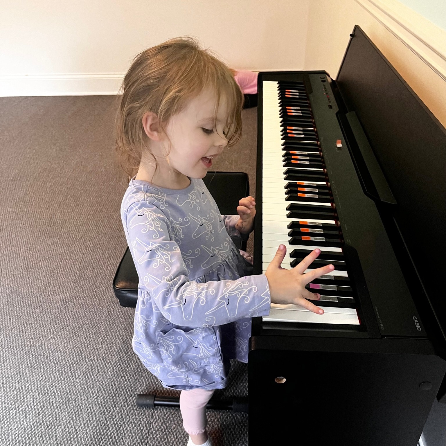 Toddler girl playing piano