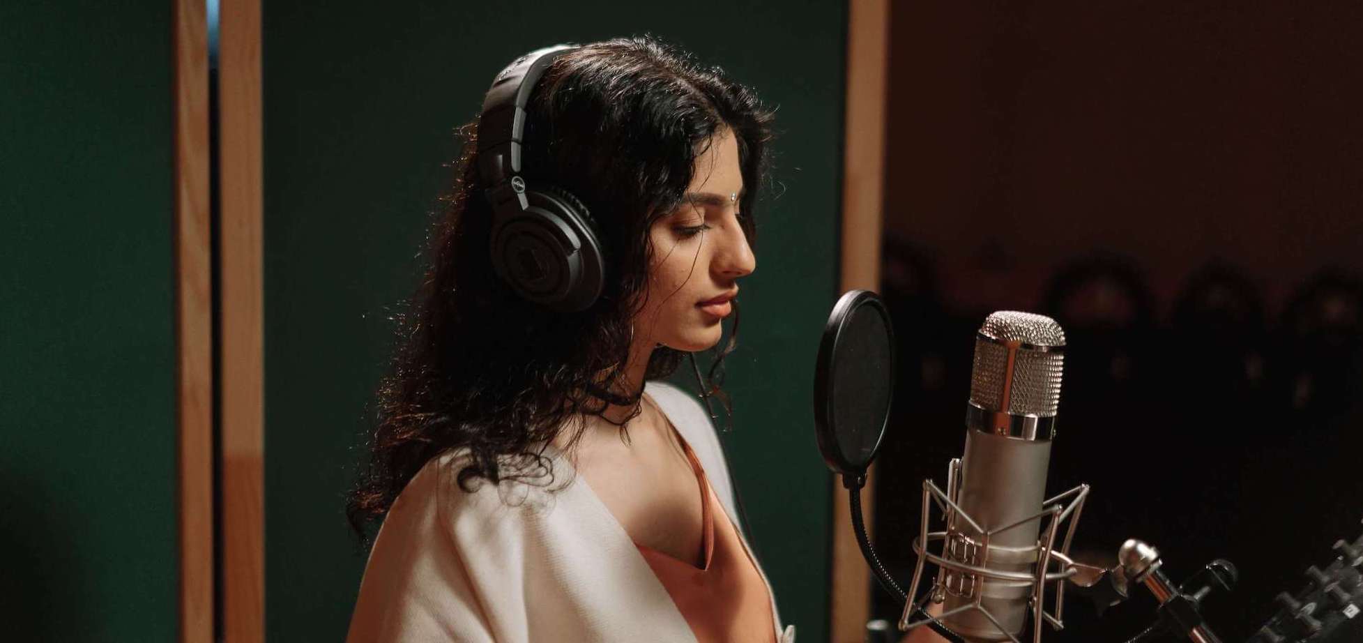 voice student singing into a microphone in a studio in Hattiesburg, MS