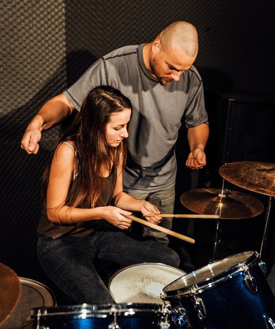 woman learning to play the drums