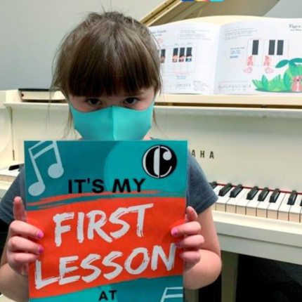 child holding first lesson sign