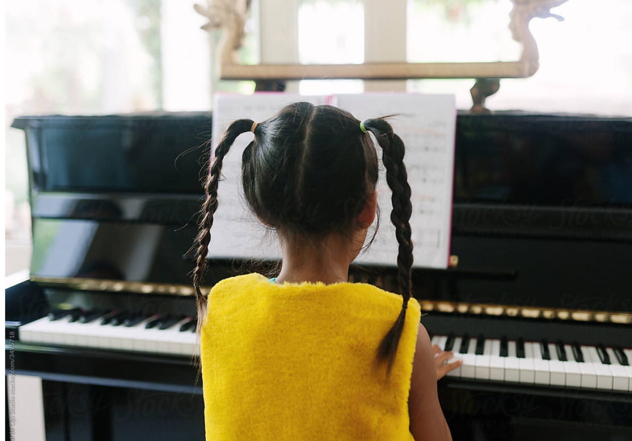 young student playing the piano