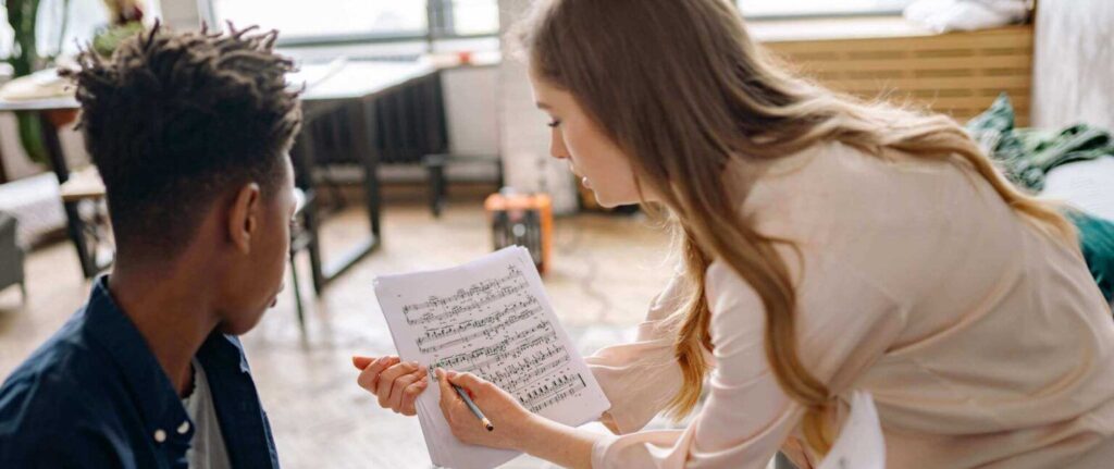 student and the piano teacher in the piano lessons