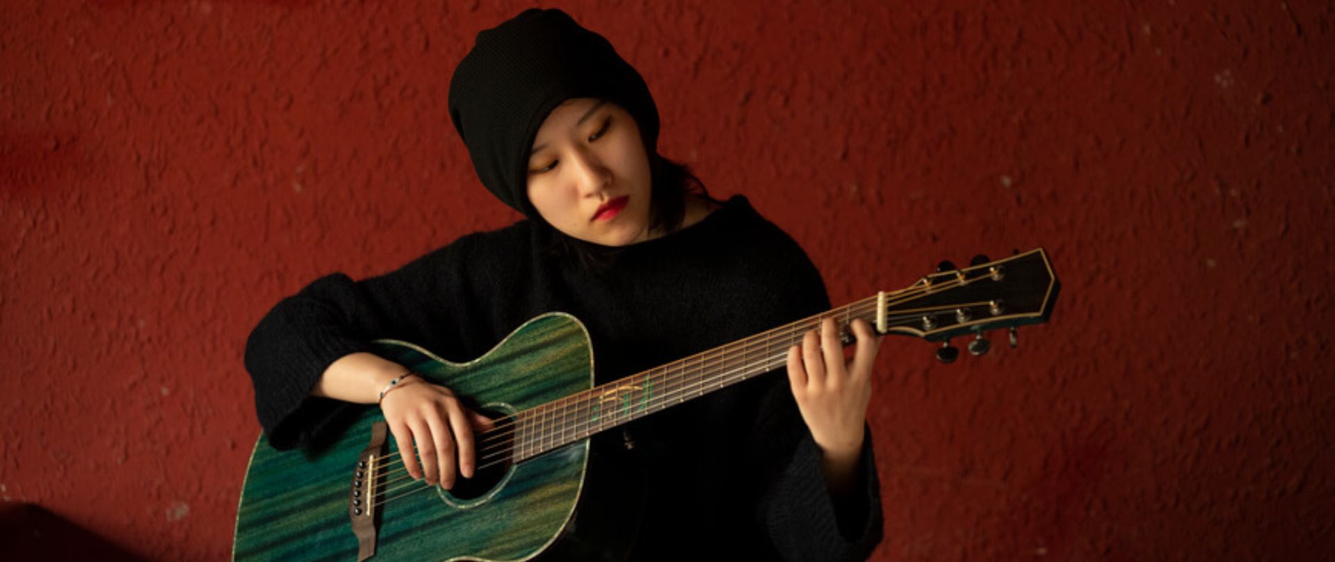 student playing the guitar