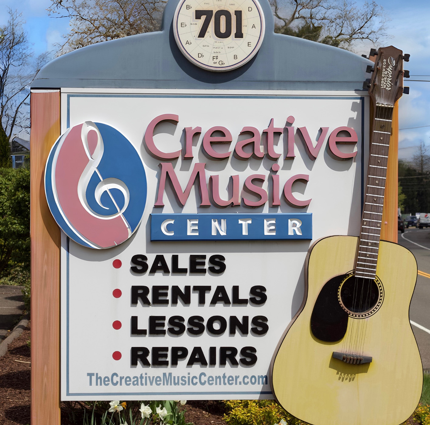 Outdoor sign for Creative Music Center that lists these services: Sales, Rentals, Lessons, and Repairs