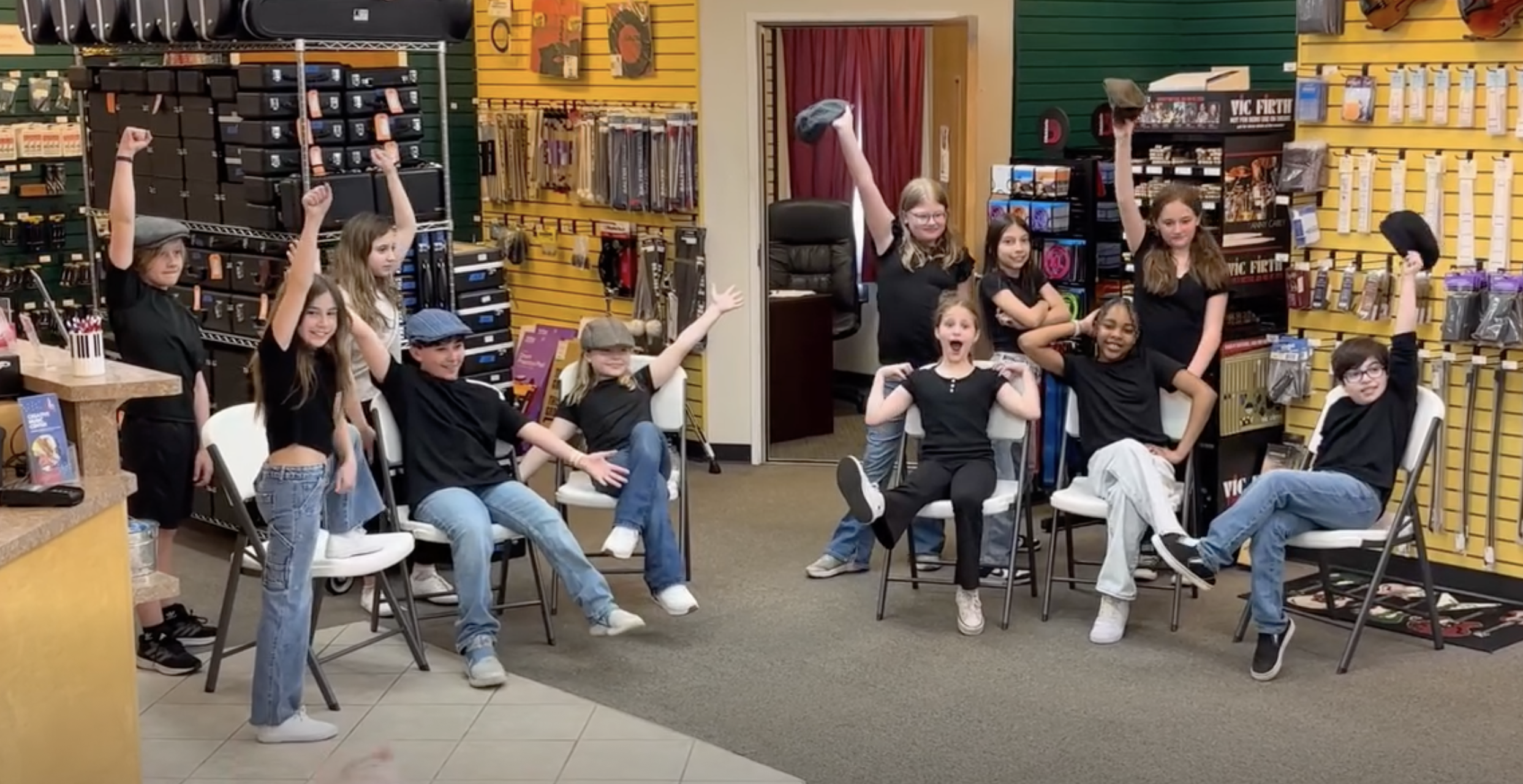 A group of kids in black shirts at musical theater camp
