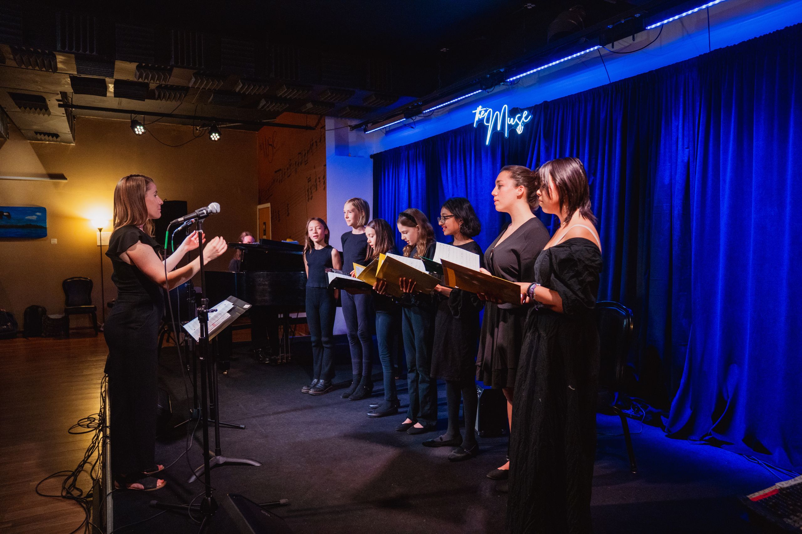 group of students singing on stage
