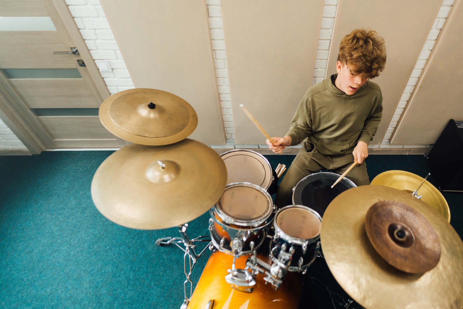 student playing the drums in the drum lessons
