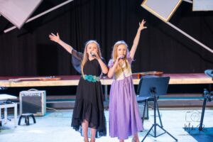 two singers performing on stage