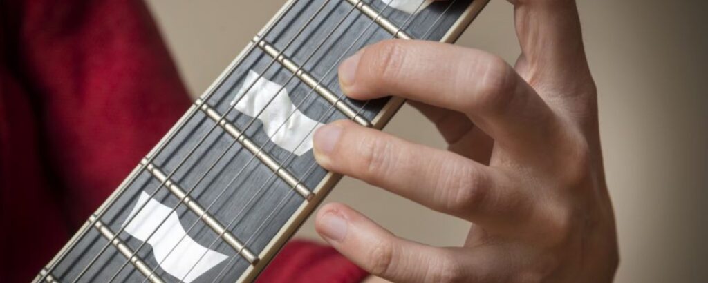 holding guitar strings