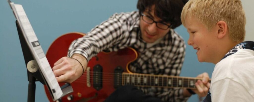 teaching how to play the guitar