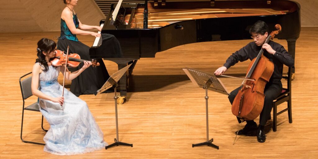 musicians playing violin, cello and piano