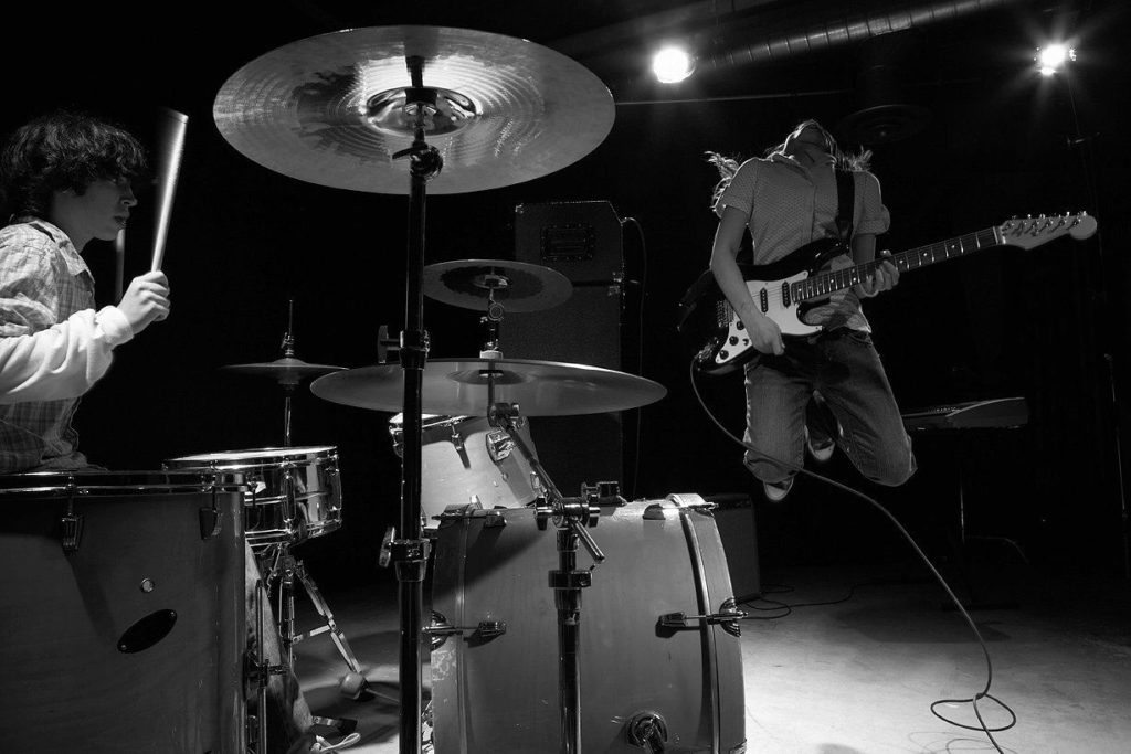 drummer and guitarist playing music