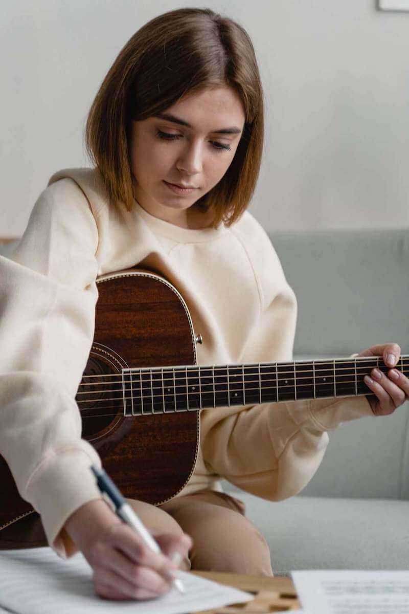 guitar student learning to play the guitar at home
