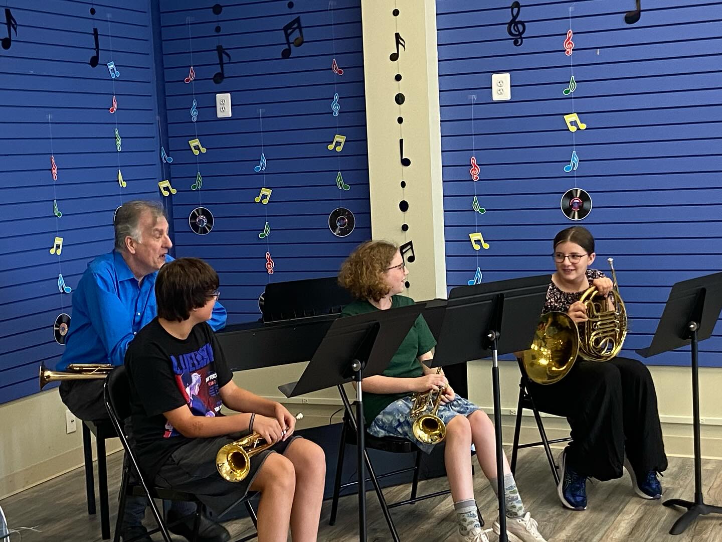 students playing brass instruments in a class