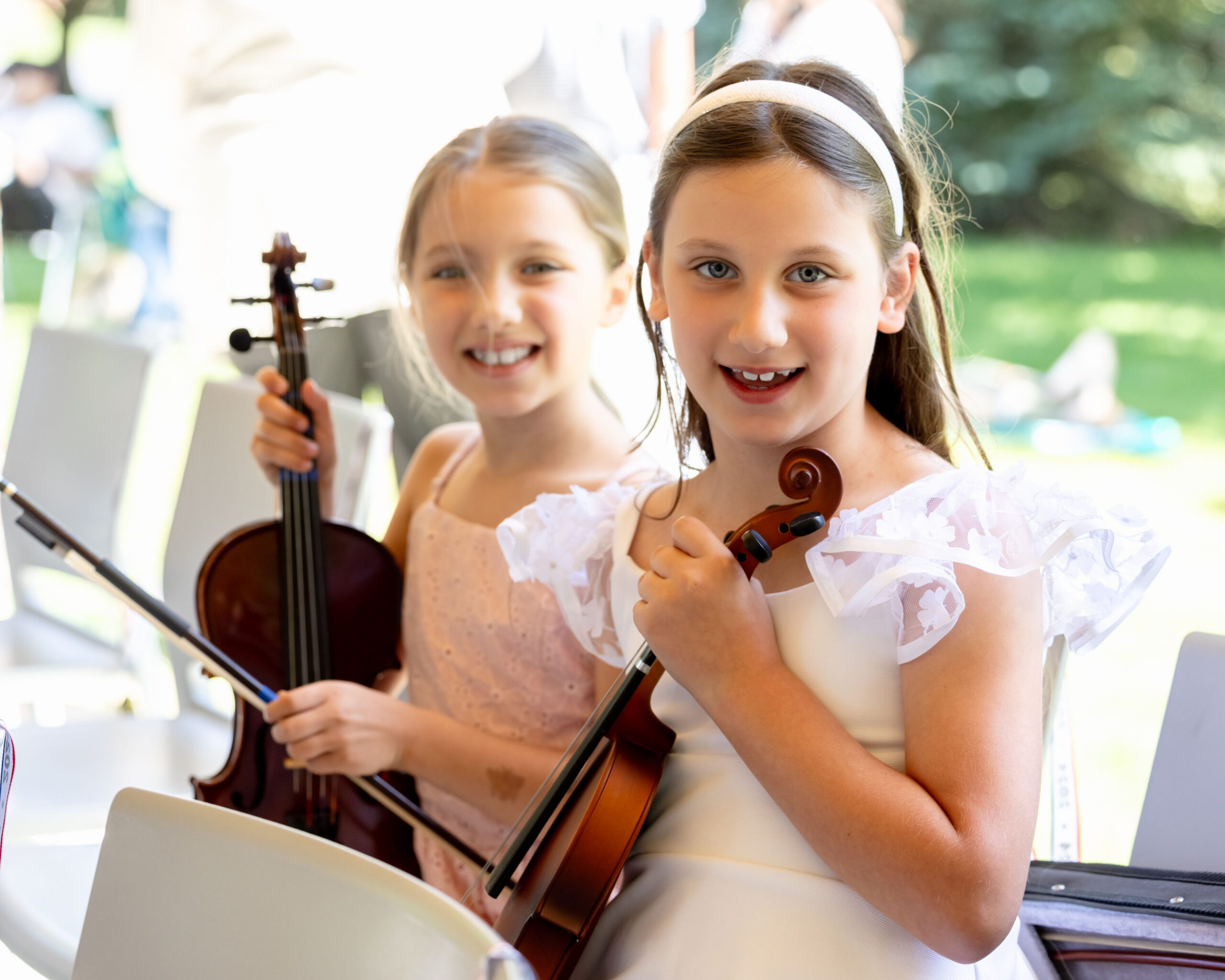 Two girls holding violins