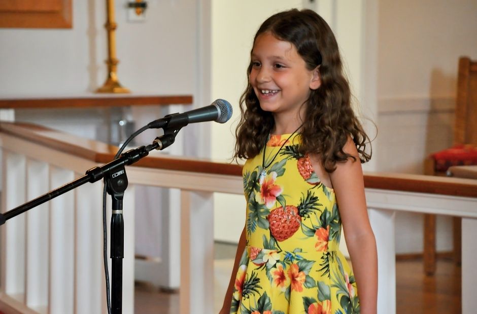 girl singing into a microphone