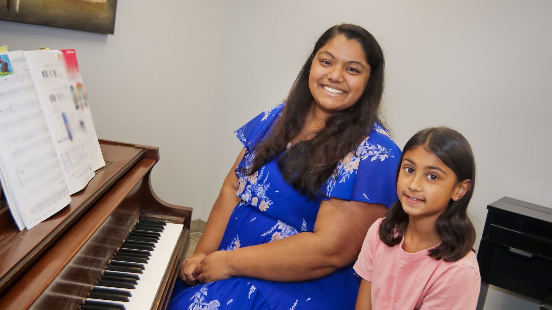 piano student and teacher sitting at the piano
