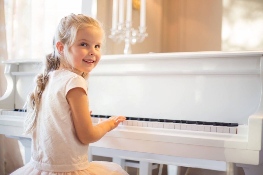 child taking lessons on a piano