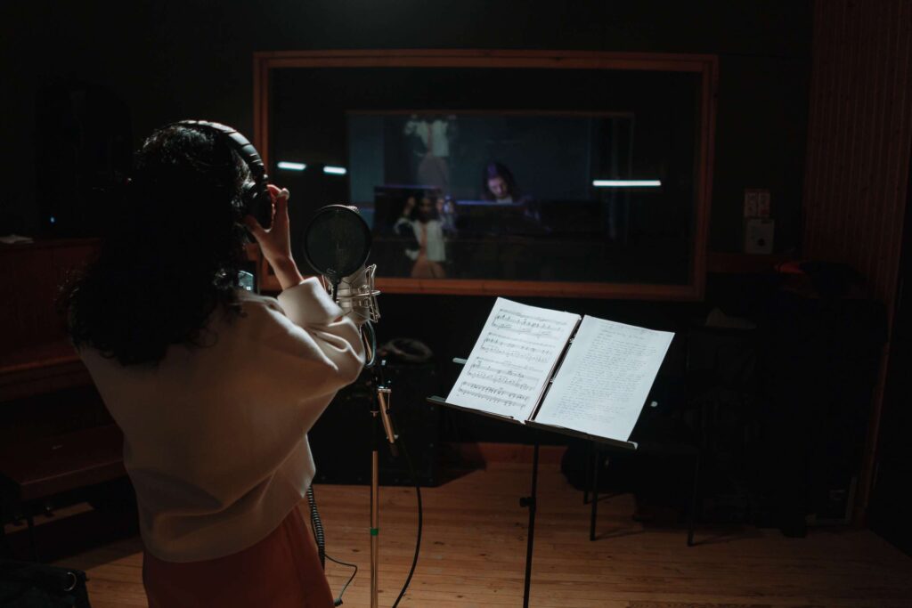 student taking singing lessons in a studio