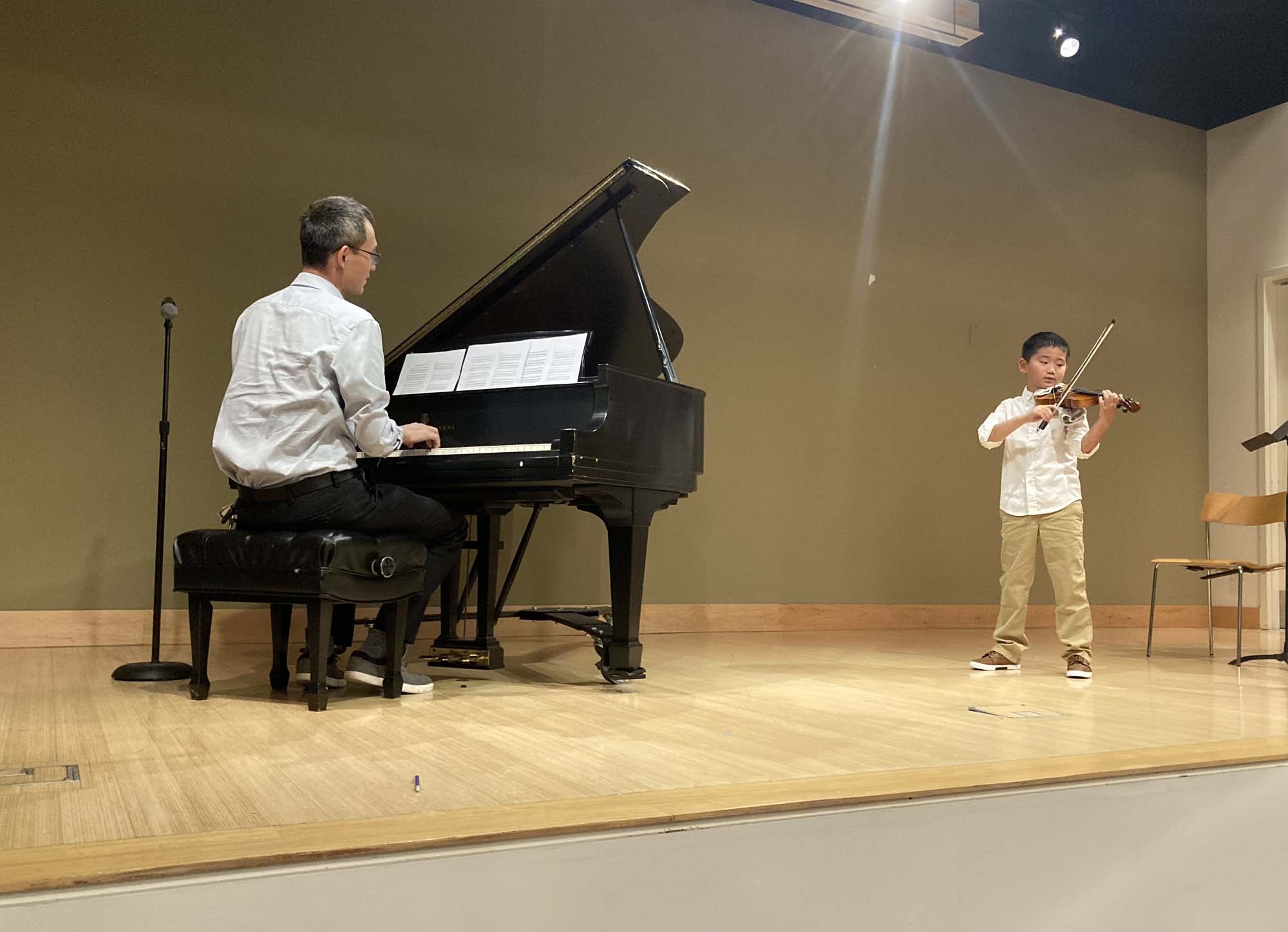 piano teacher and the student learning musical notes at home in Woodlands, TX