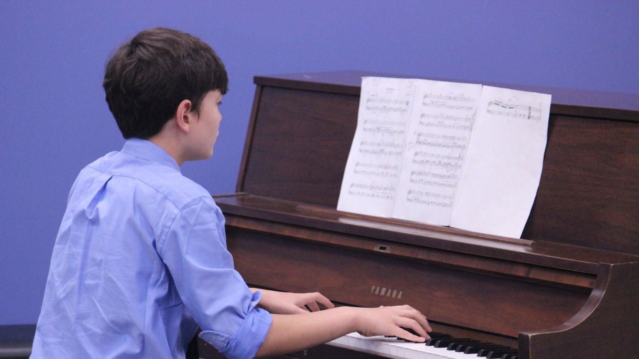 Student playing piano in studio At Marlton Music Academy. Marlton, NJ