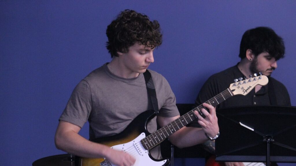 student playing the guitar at marlton music academy