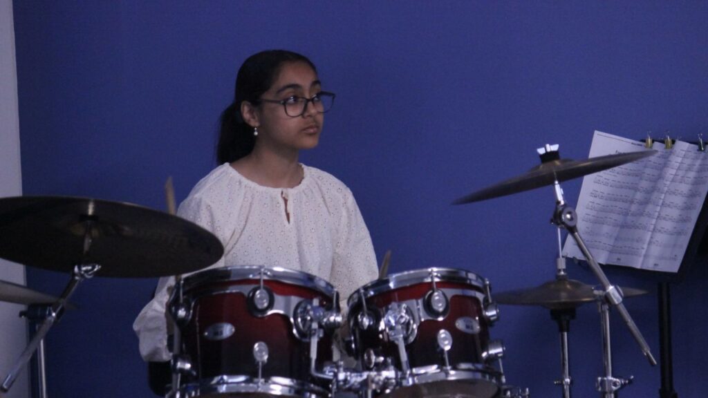 student playing the drums