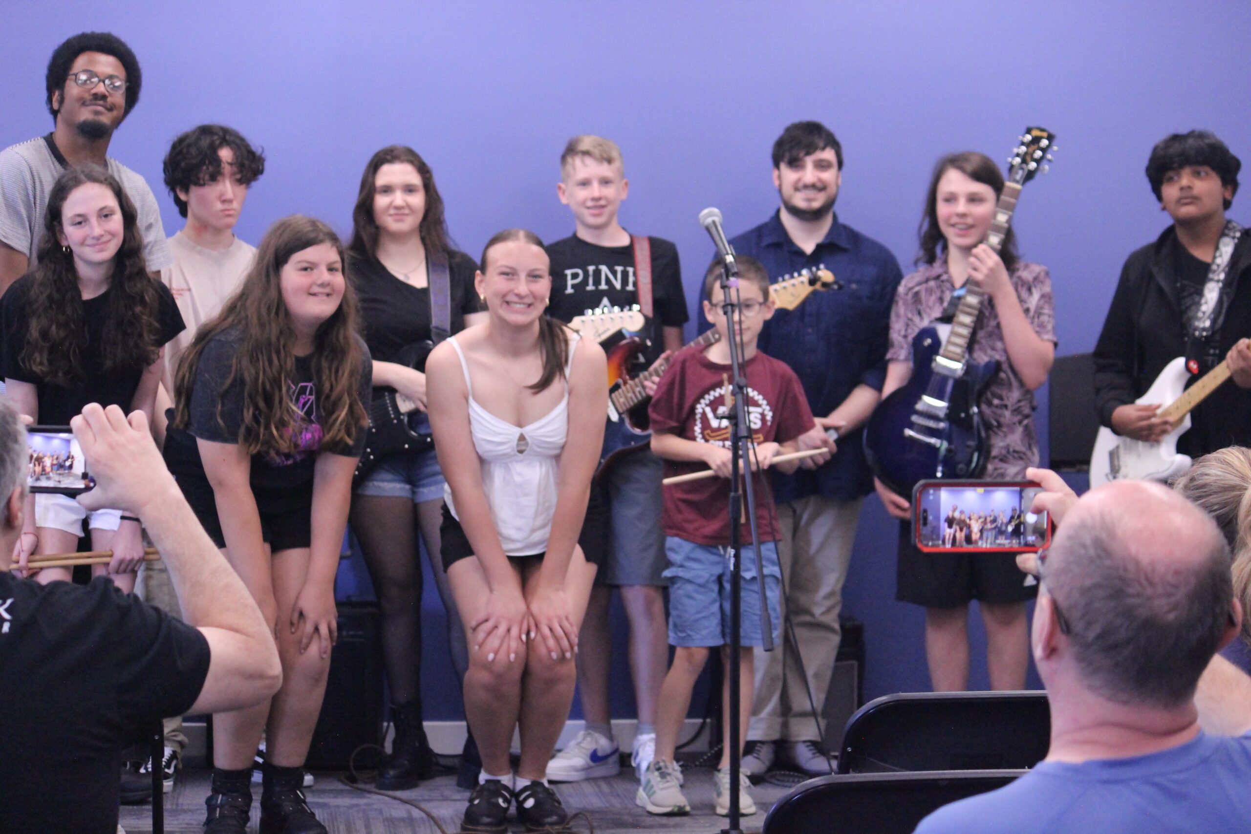 Group of kids holding instruments and smiling at the camera