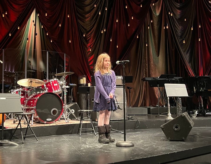 voice student singing into a microphone in a studio in Elgin, IL