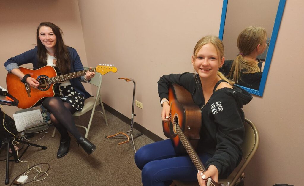 Student learning to play the guitar in SOUTH ELGIN, IL