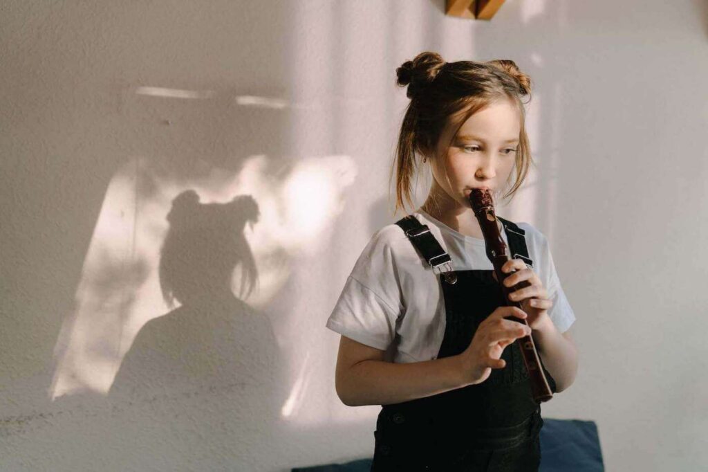 young student playing the wooden flute