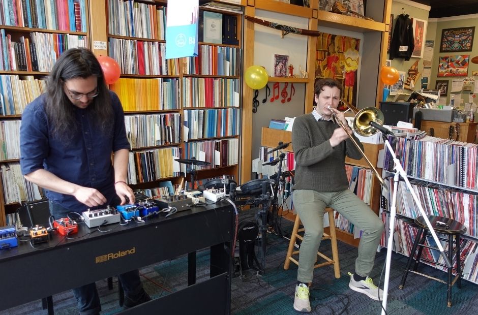 trombone player performing alongside an electronic artist