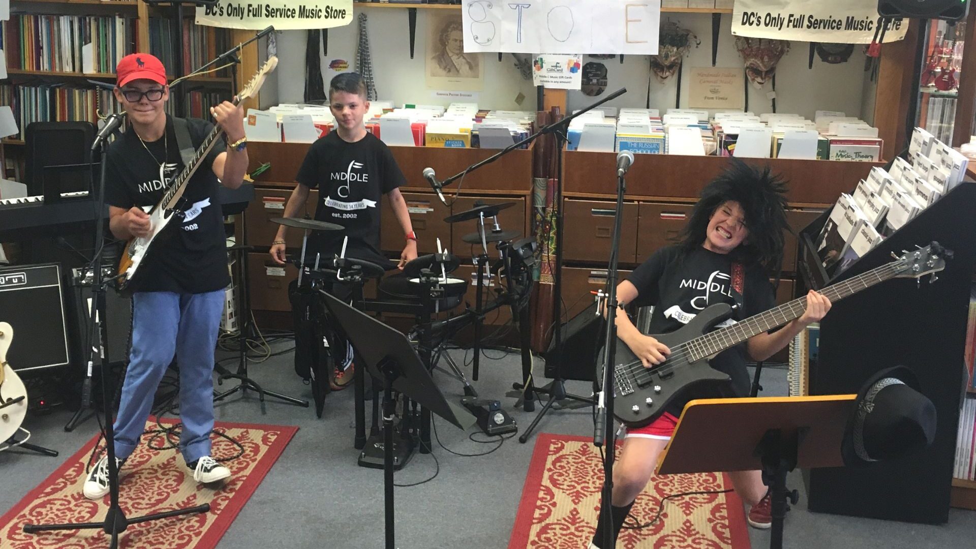 student band performing in the store posing with their instruments