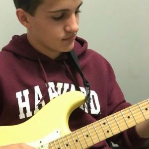 student playing electric guitar