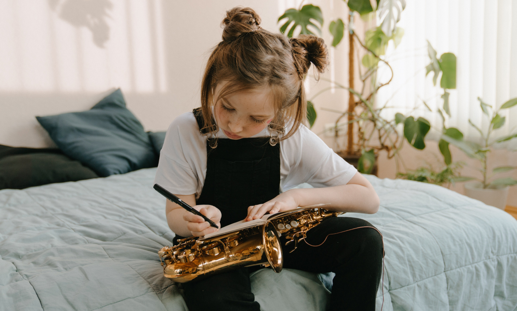 Young student learning to play the saxophone at home Caldwell NJ