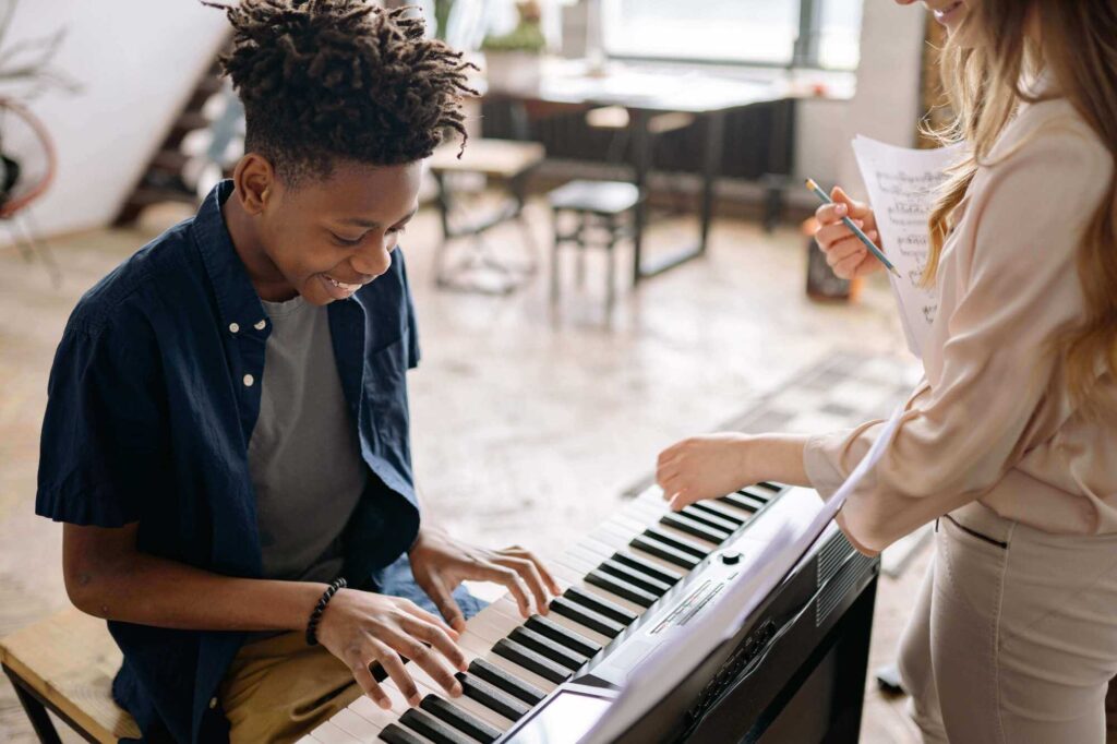 Young student playing the piano