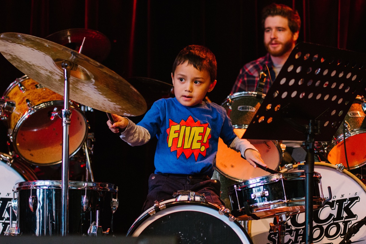little boy playing drums