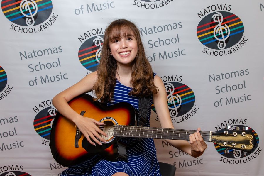 girl playing acoustic guitar 