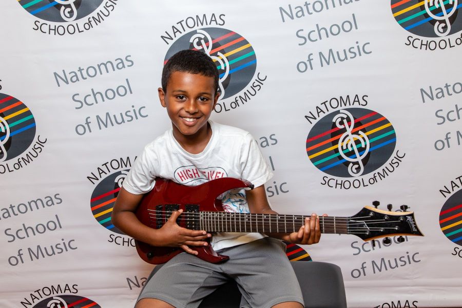 student playing electric guitar