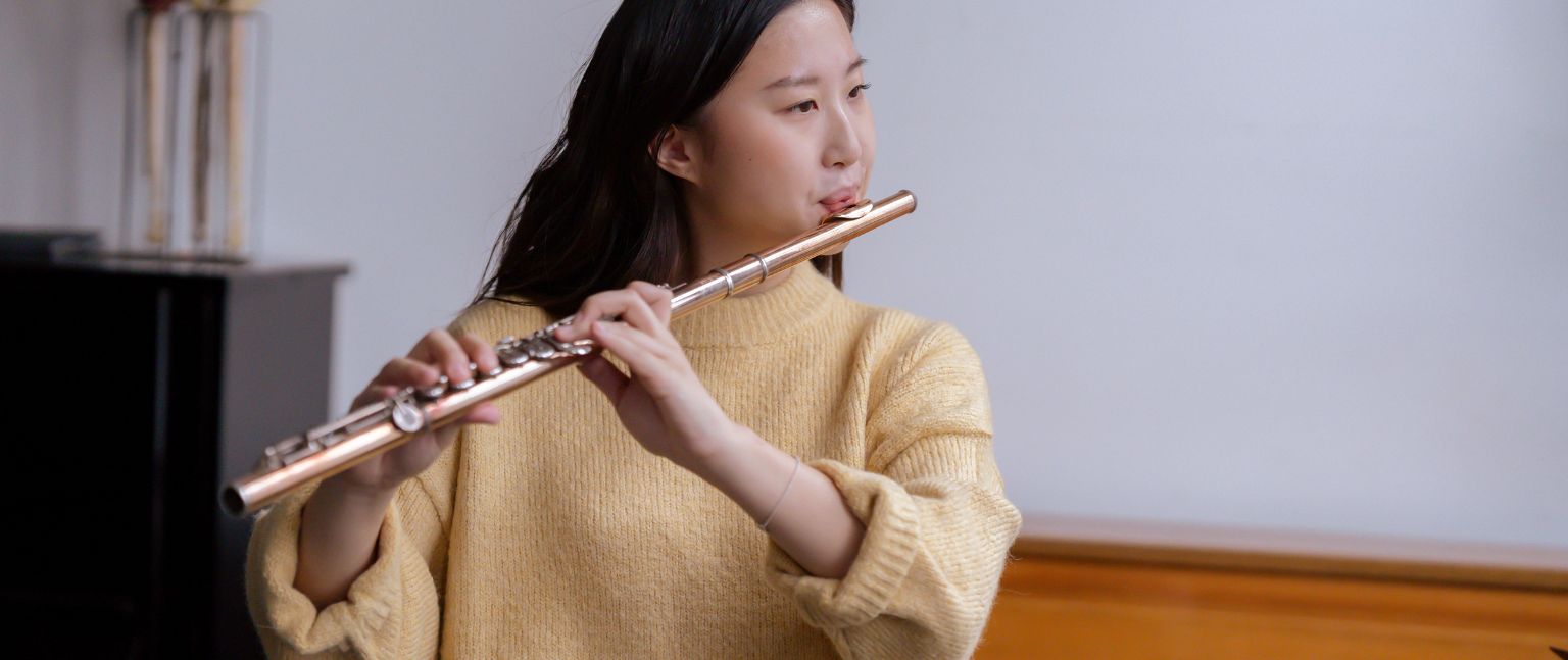 student playing the flute