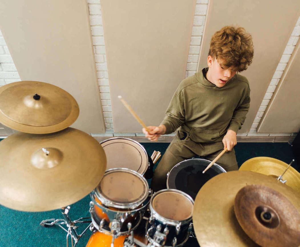 student playing the drums in the drum lessons Aurora CO