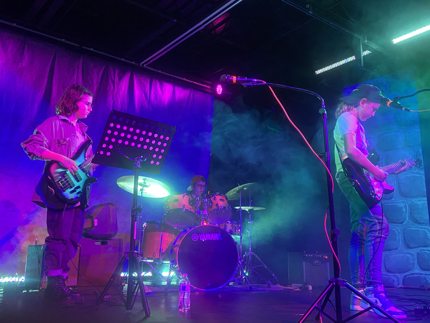 Students Playing Guitar and Drums in Neighborhood Music School