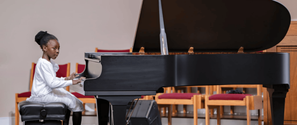 student playing the piano at the recital