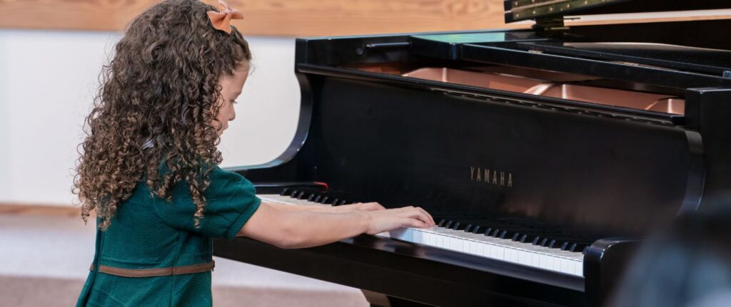 pre school student playing the piano