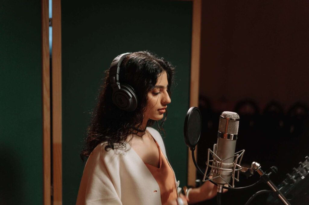 student taking singing lessons in a studio