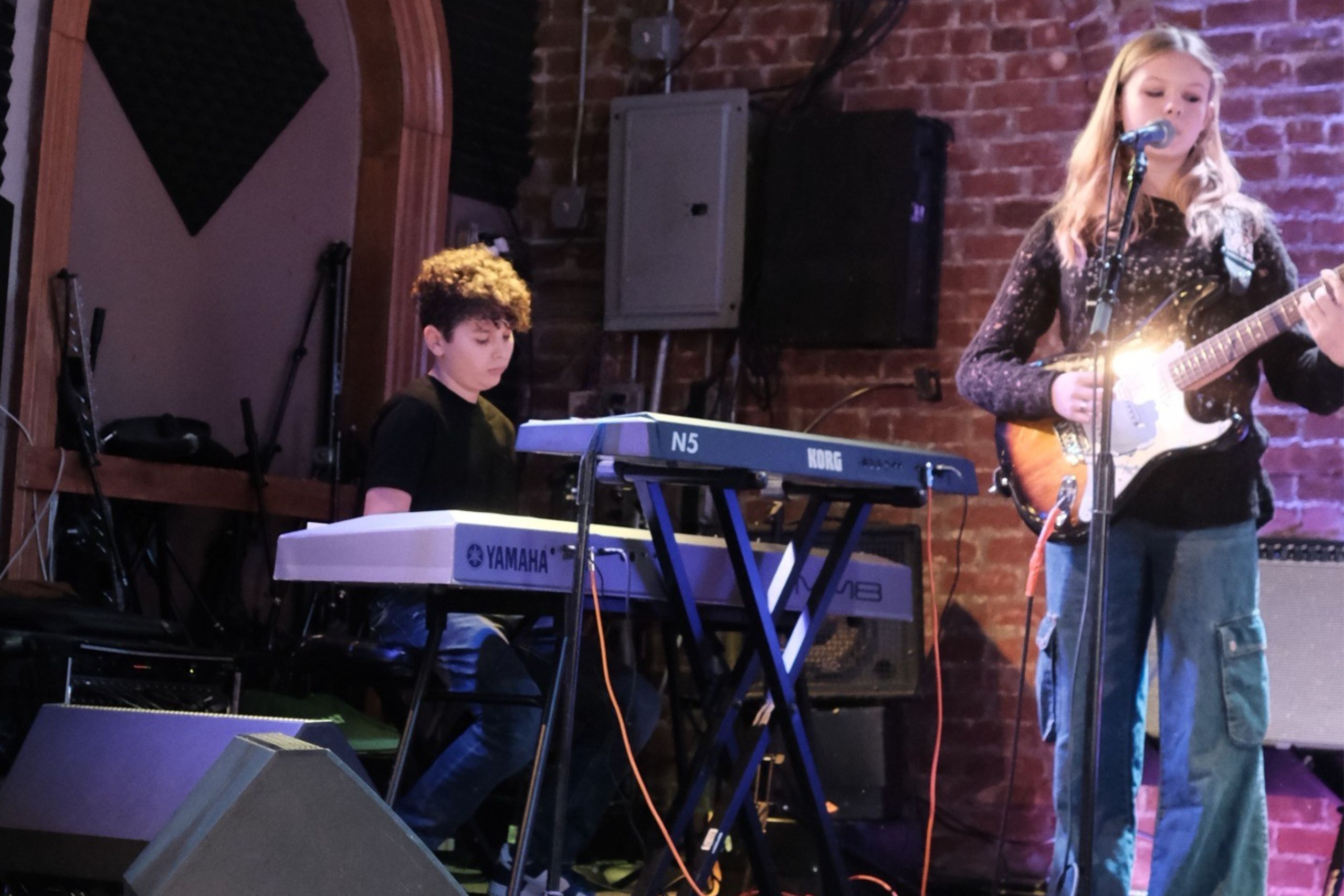 Piano and bass students performing on stage