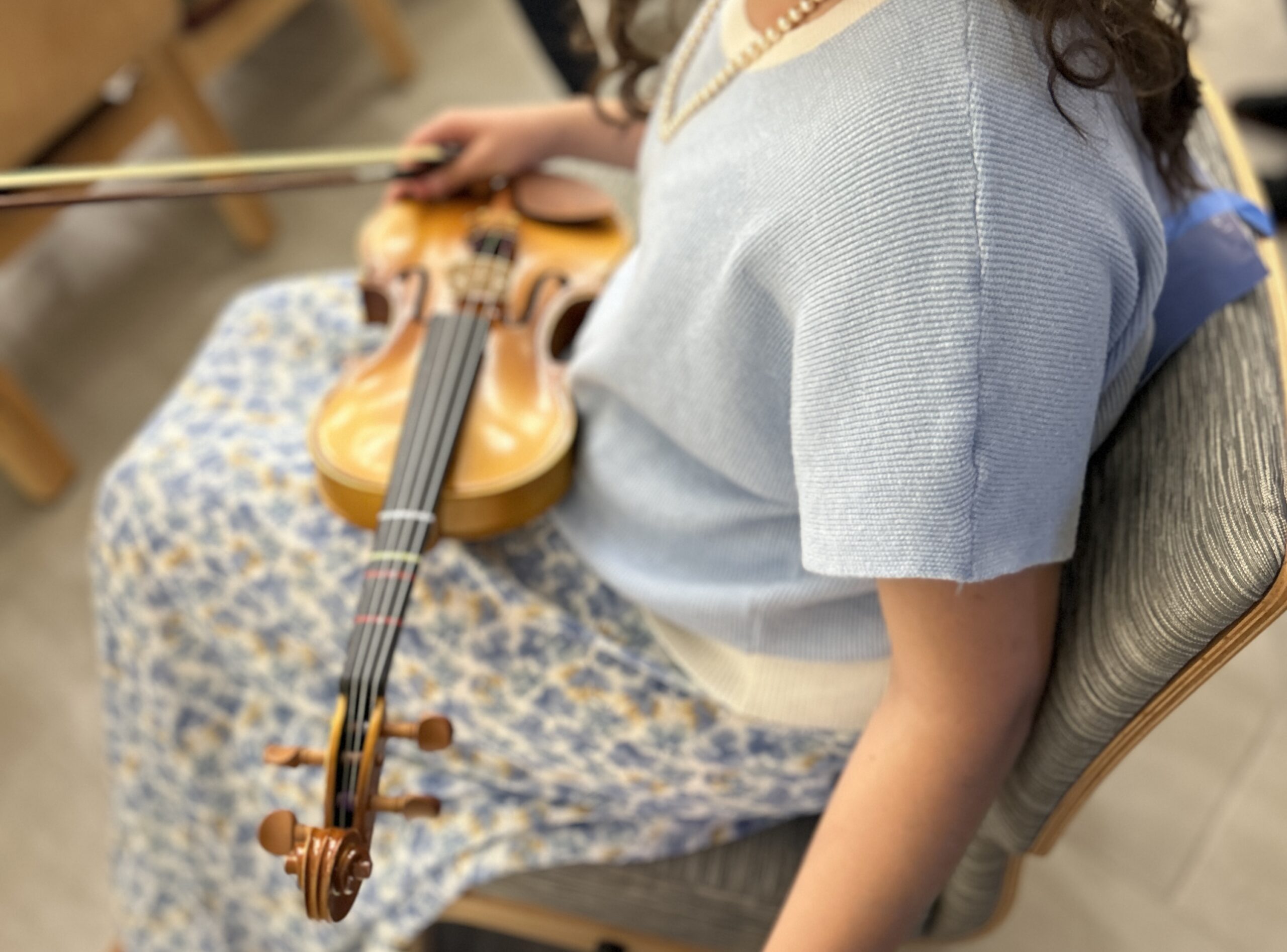 Student with a violin on their lap