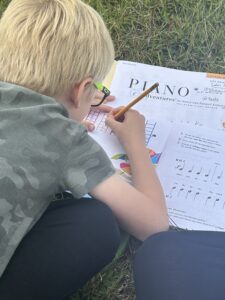 Boy working in piano book