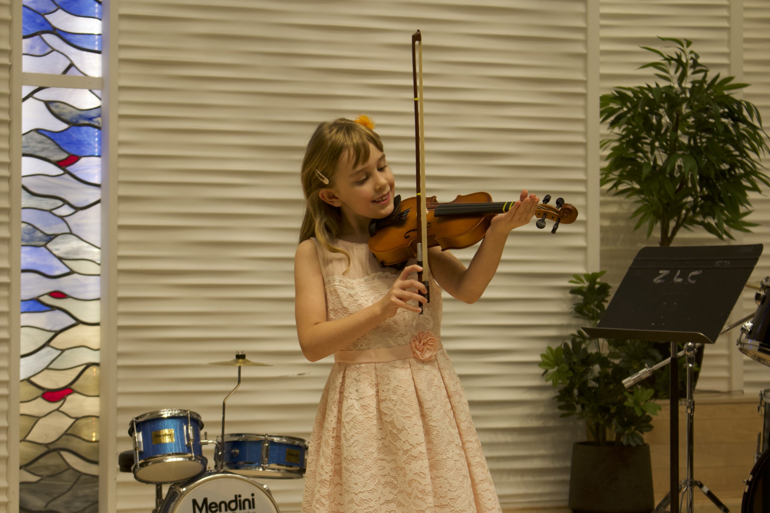Young girl on stage playing the violin